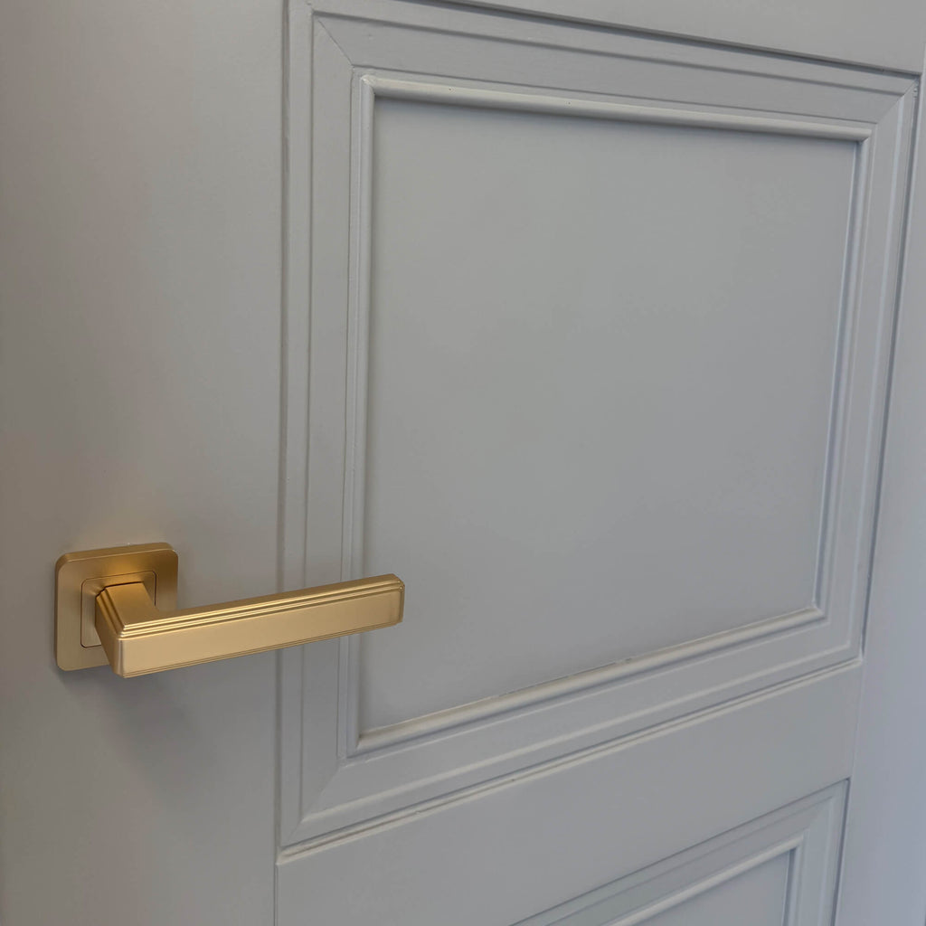 An Amsterdam White Primed 40mm Internal Door, painted grey, with an Ares Satin Brass Square Rose Handle.