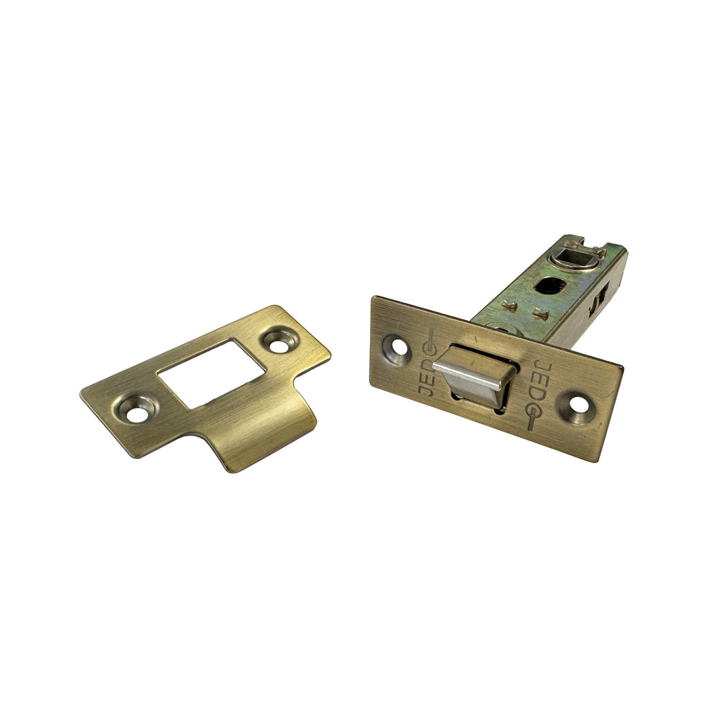 Angled view of the front of a Antique Brass Tubular Latch.