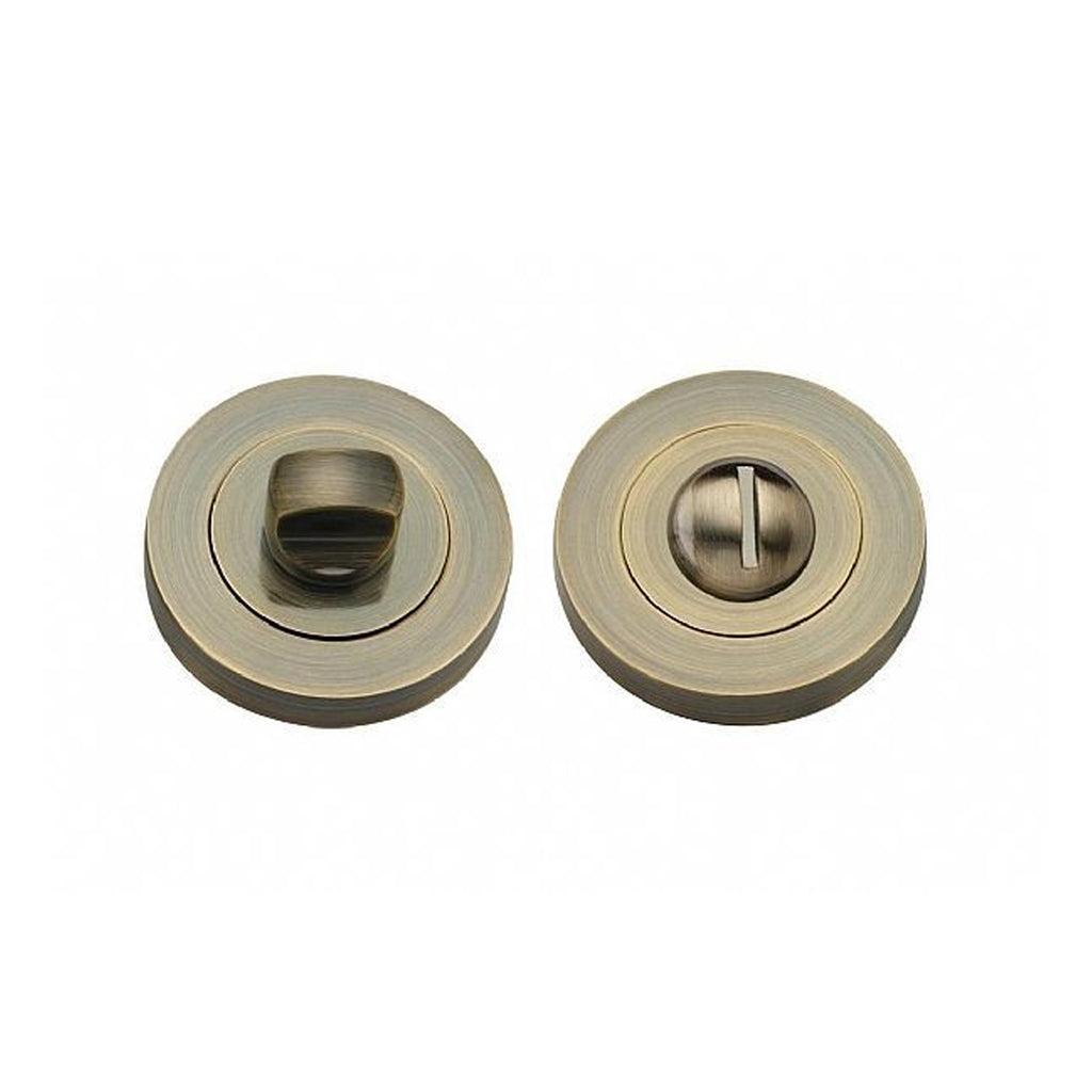 An Antique Brass WC Round Thumbturn Set on a white background