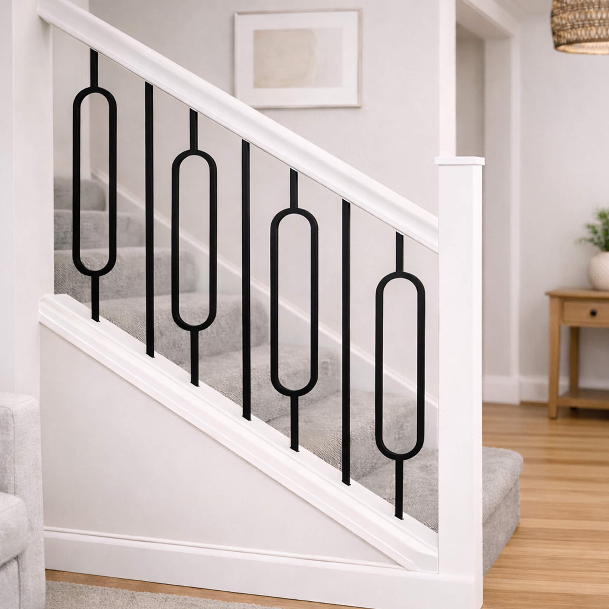 White Primed Staircase with Black Oval Spindles in a home setting.