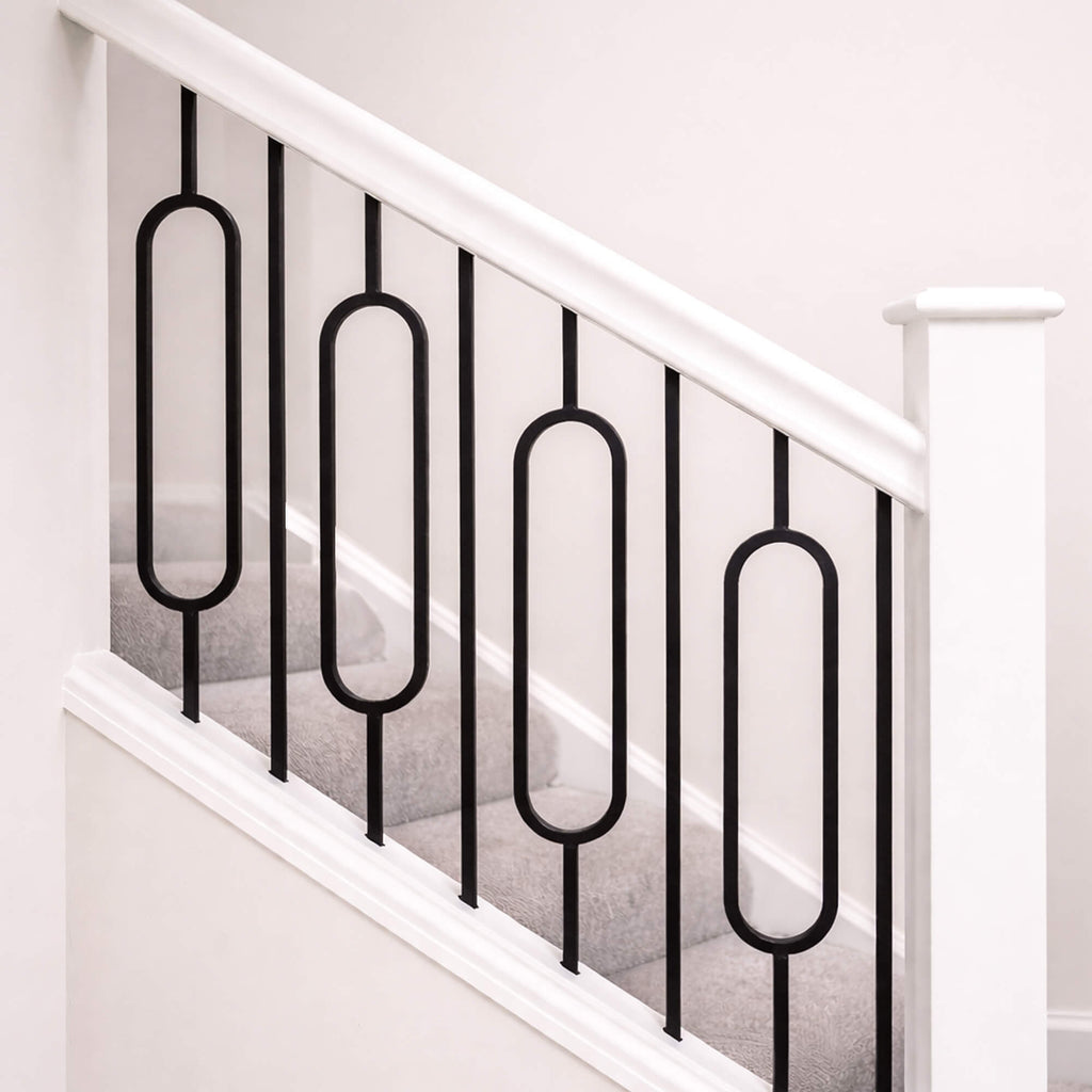 Close-up of Black Oval Spindles on a White Primed Staircase with a blank newel post