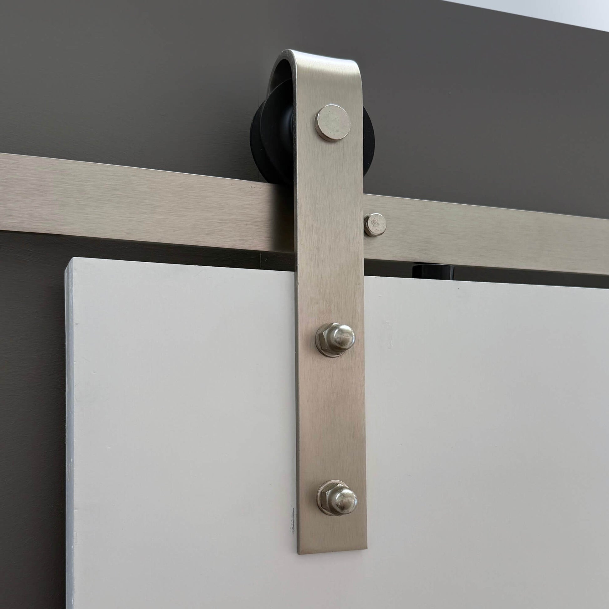 Close-up of the Brushed Steel Barn Door Track mechanism.