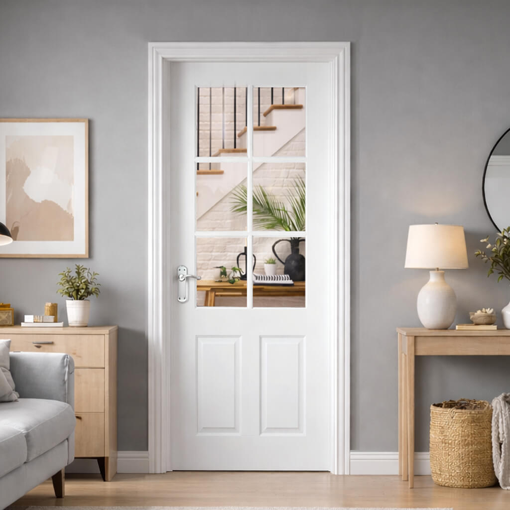 A Cambridge White Primed 6 Lite Pre-glazed Door in a living room setting, with grey walls and wooden furniture looking out onto a hallway.