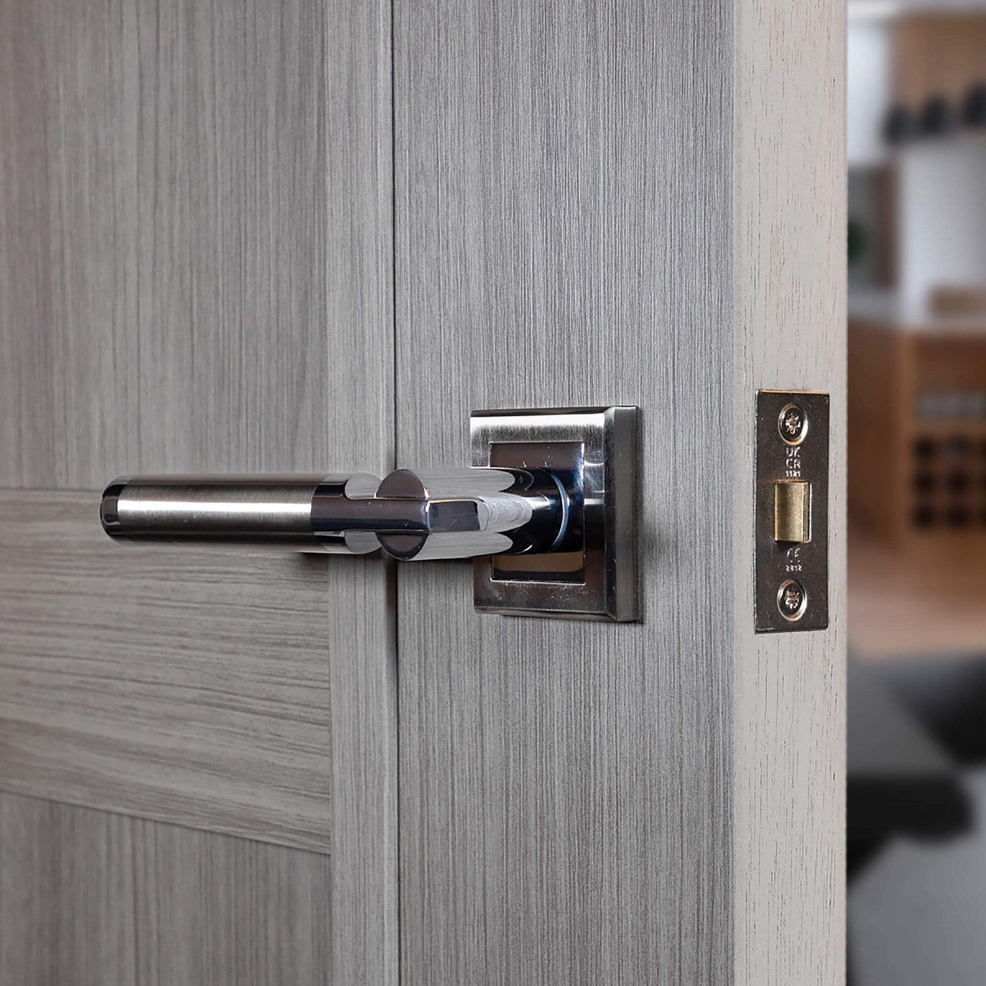 Cumulus Nickel Brushed & Polished Chrome Square Rose Handle on a wooden door