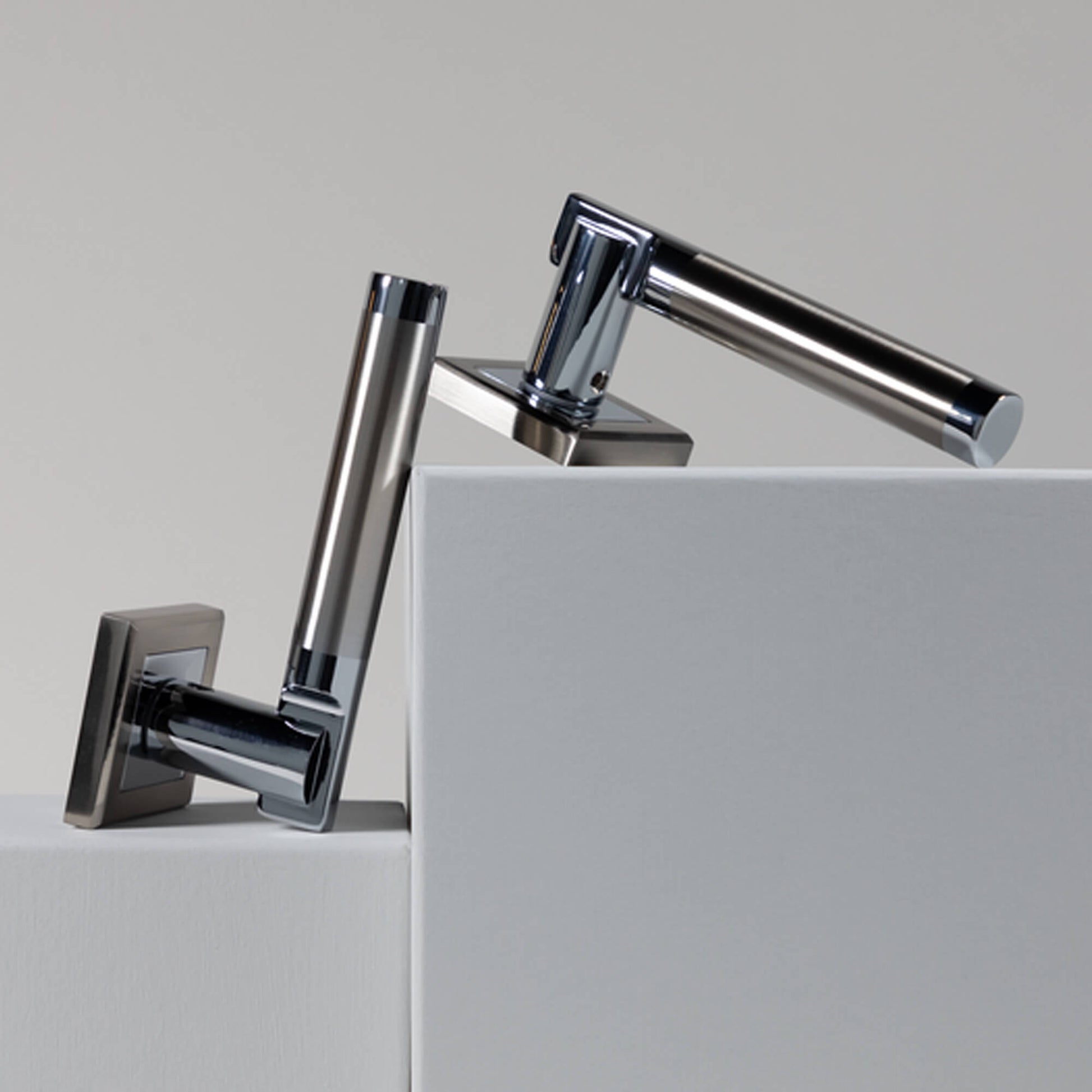 A pair of Cumulus Nickel Brushed & Polished Chrome Square Rose Handles on a neutral background