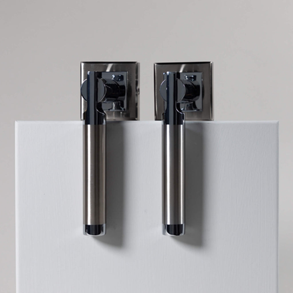 A set of Cumulus Nickel Brushed & Polished Chrome Square Rose Handles on a white background
