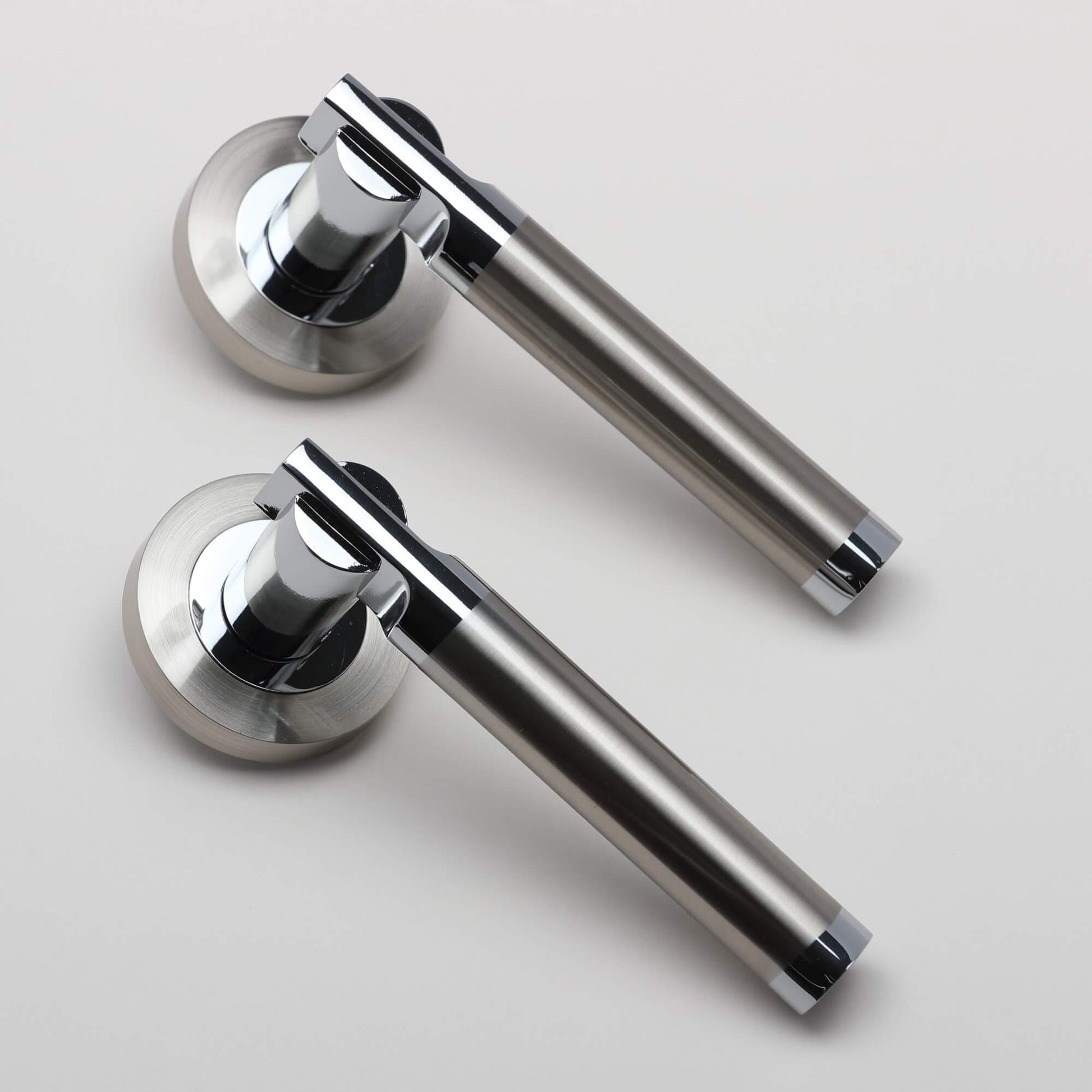 A side view of a pair of Cumulus Nickel Brushed & Polished Chrome Handles on a light grey background.