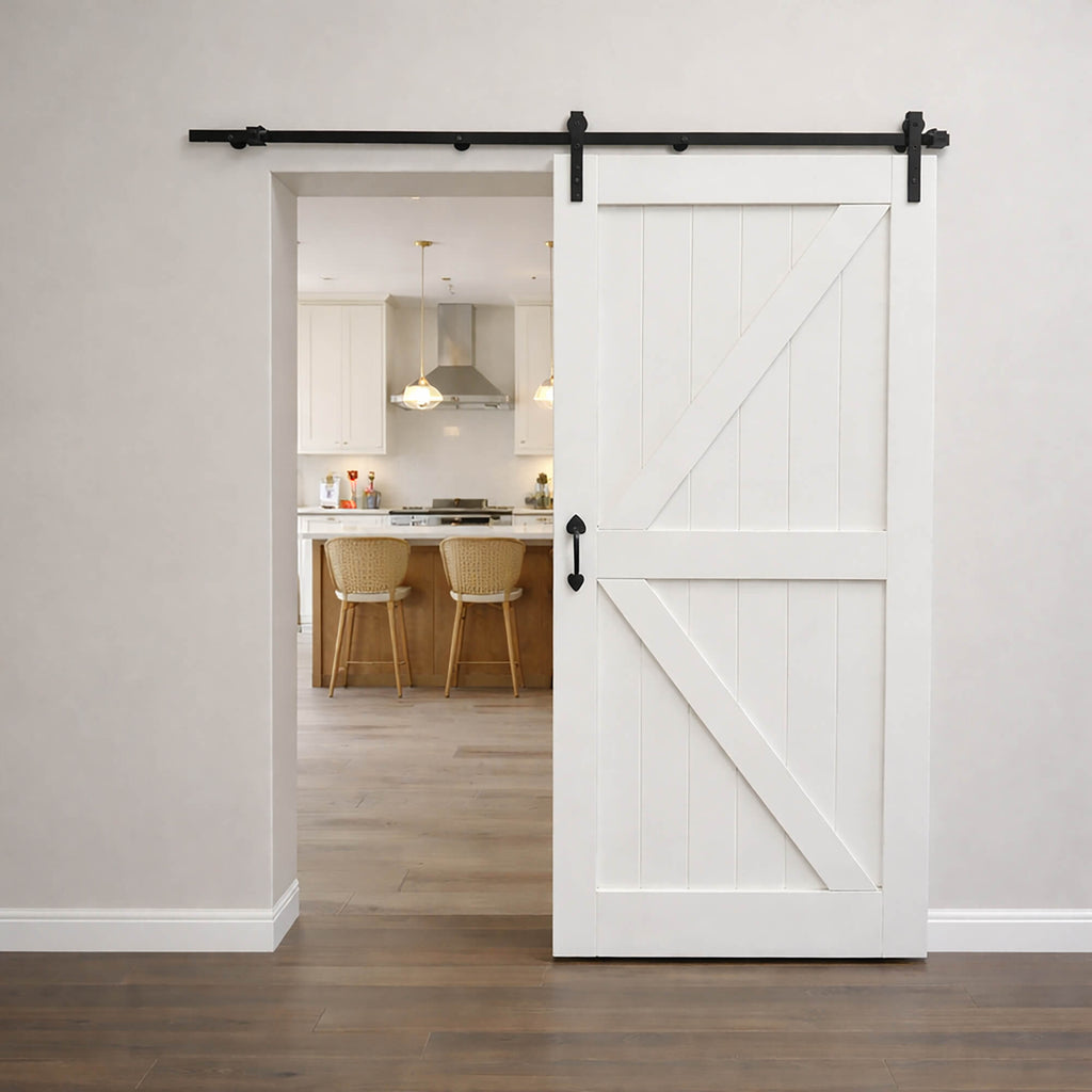An Easton White Primed Barn Door Set in a modern home interior looking into a kitchen setting.