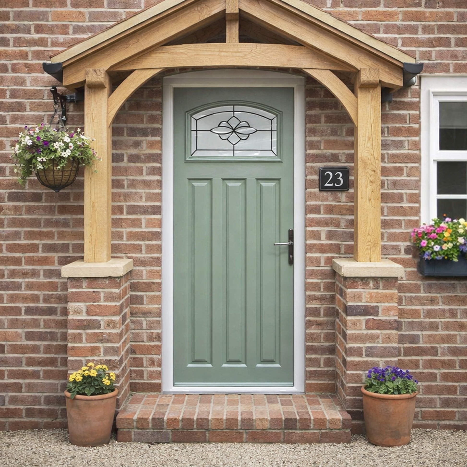 Edwardian Composite GRP External Door with decorative glass panel on a traditional brick exterior home setting.