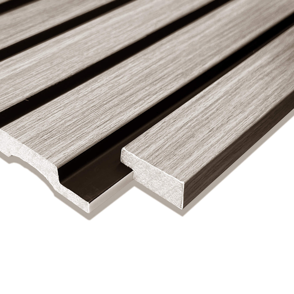 Close-up of a Grey Aqua Slatwall Left Trim being positioned in place on a white background