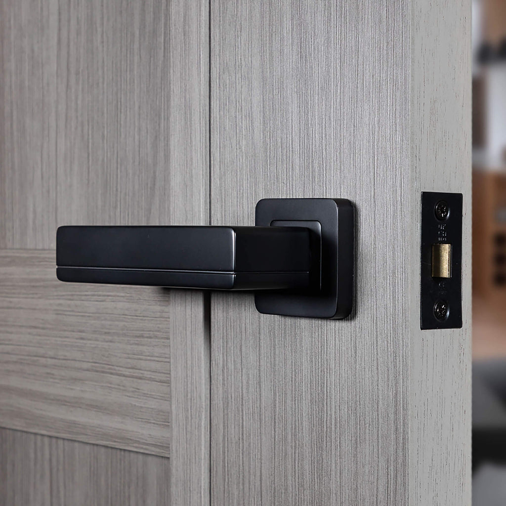 A Hermes Flat Black Square Rose Handle on a laminate internal door