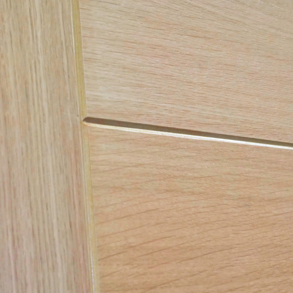 Close-up of the visible woodgrain and v-grooves on an Iseo White Oak FD30 44mm Internal Fire Door.