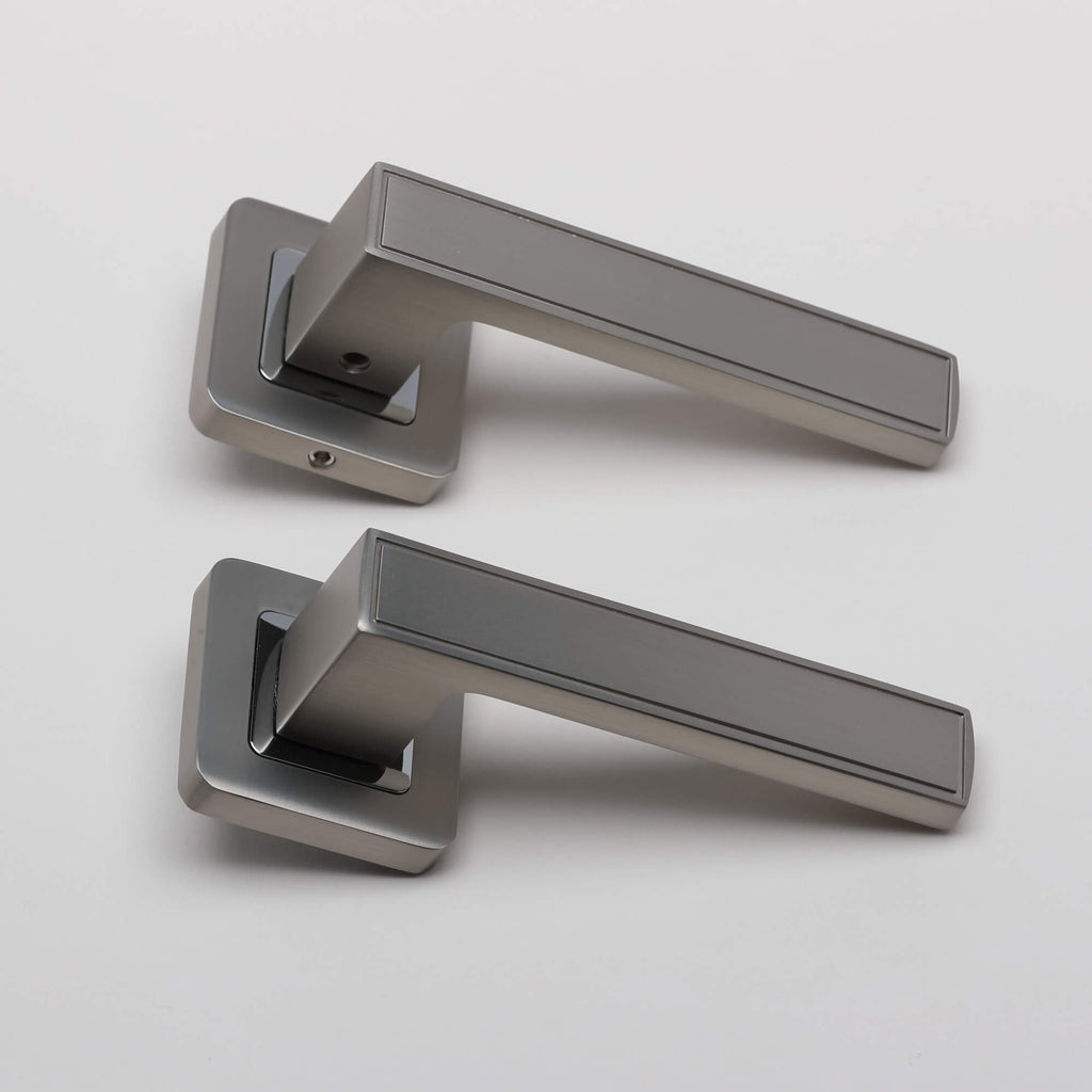 A side view of a pair of Jupiter Matt Satin Nickel & Polished Chrome Square Rose handles on a light grey background.