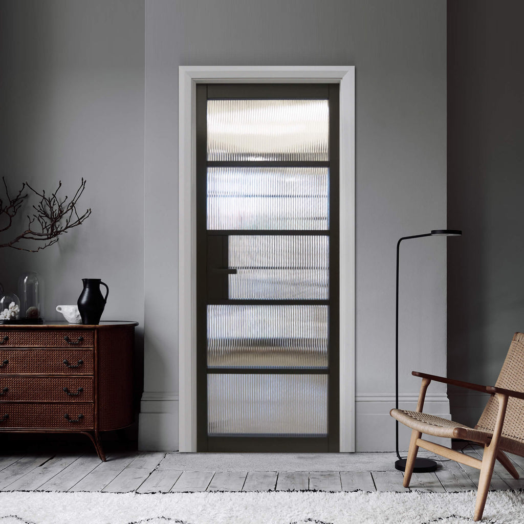 A Kew Black Primer Plus 5 Lite Reeded Glass Door in a home interior setting.