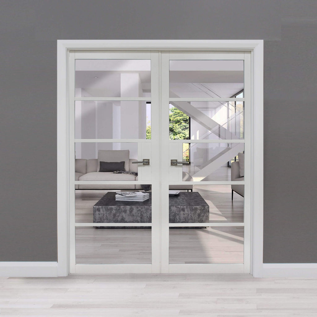 A Kew White Primer Plus 5 Lite Pre-Glazed Double Door Set, looking into a modern living room, in a home interior setting.