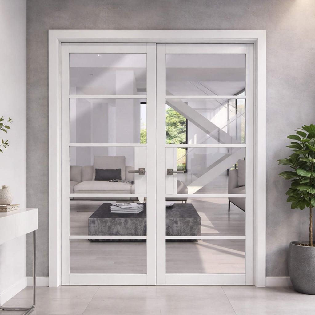 A Kew White Primer Plus 5 Lite Pre-Glazed Double Door Set, looking into a modern living room, from a home hallway.