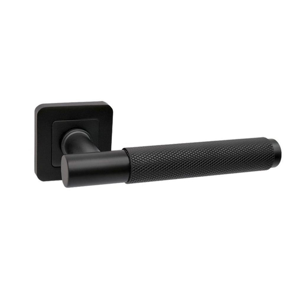 A Knurled Flat Black Square Rose door handle on a white background