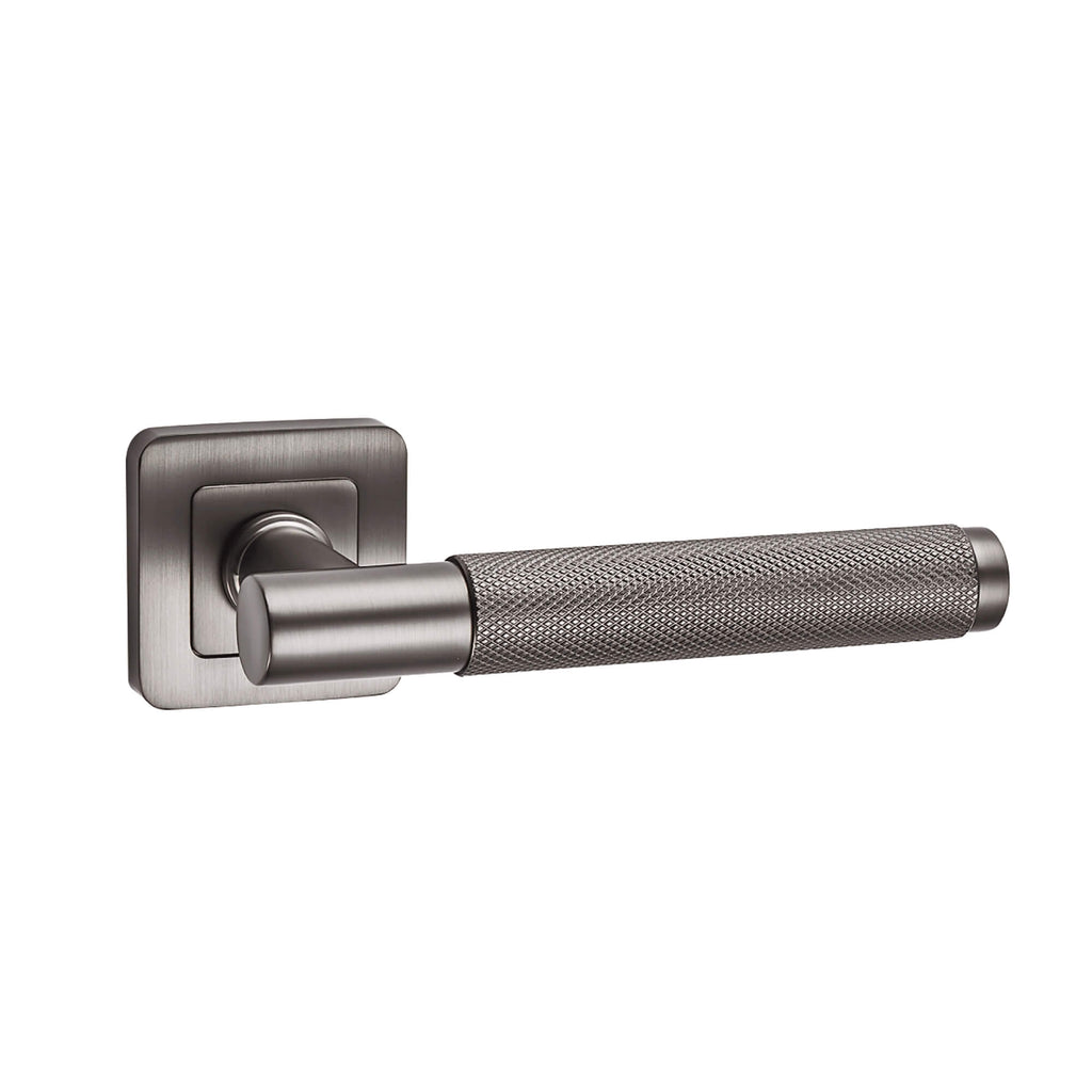 A Knurled Matt Satin Black Square Rose Door Handle on a white background