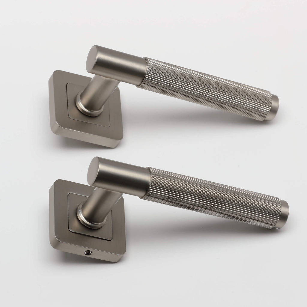 A side view of a pair of Knurled Matt Satin Nickel Square Rose Handles on a light grey background.