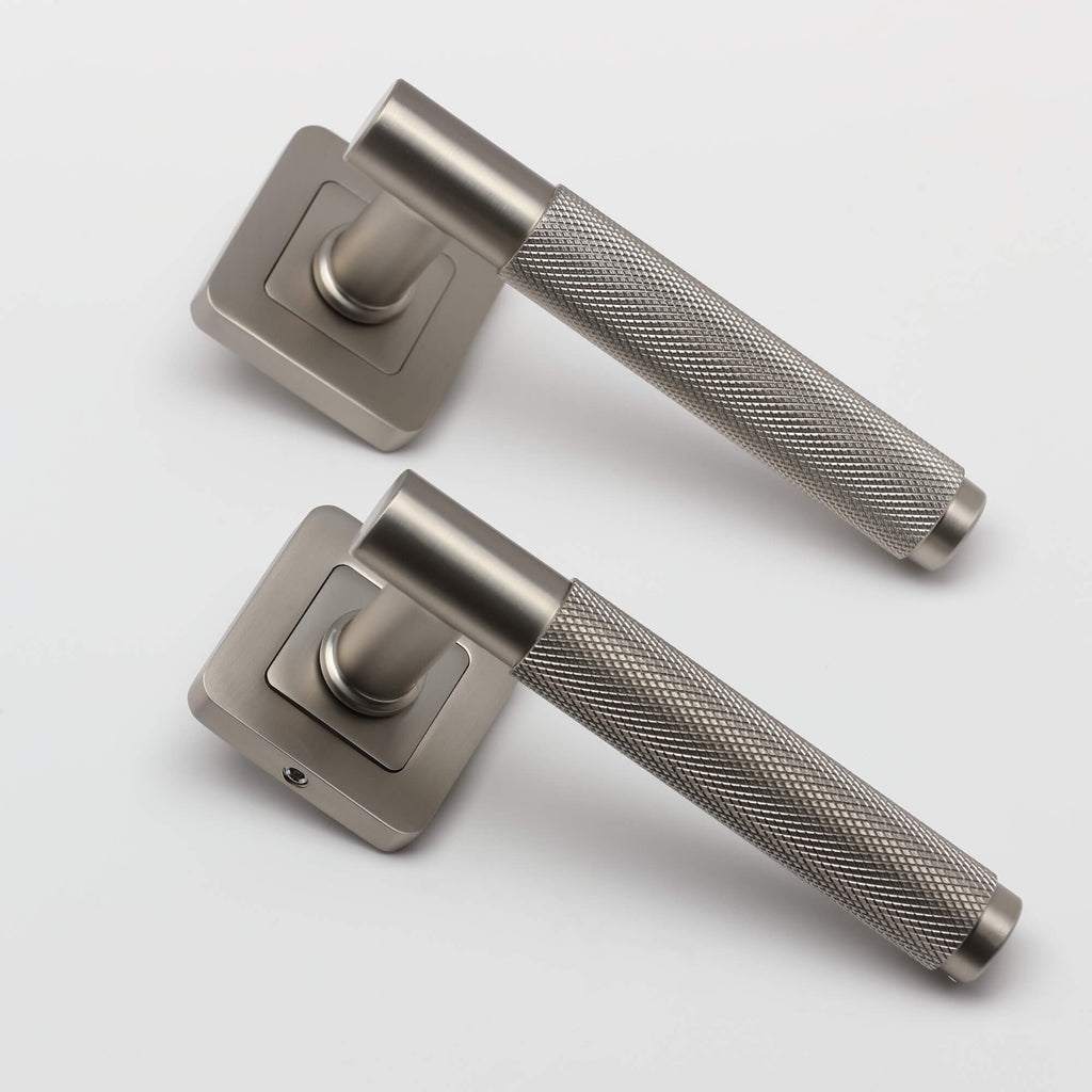 A angled view of a pair of Knurled Matt Satin Nickel Square Rose Handles on a light grey background.