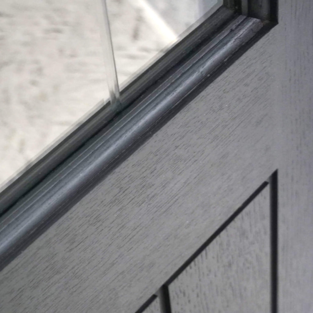 Close-up of a Mexicano Black Primer Plus 1 Lite Pre-Glazed Door showing the grain and the diamond cut toughened glass.