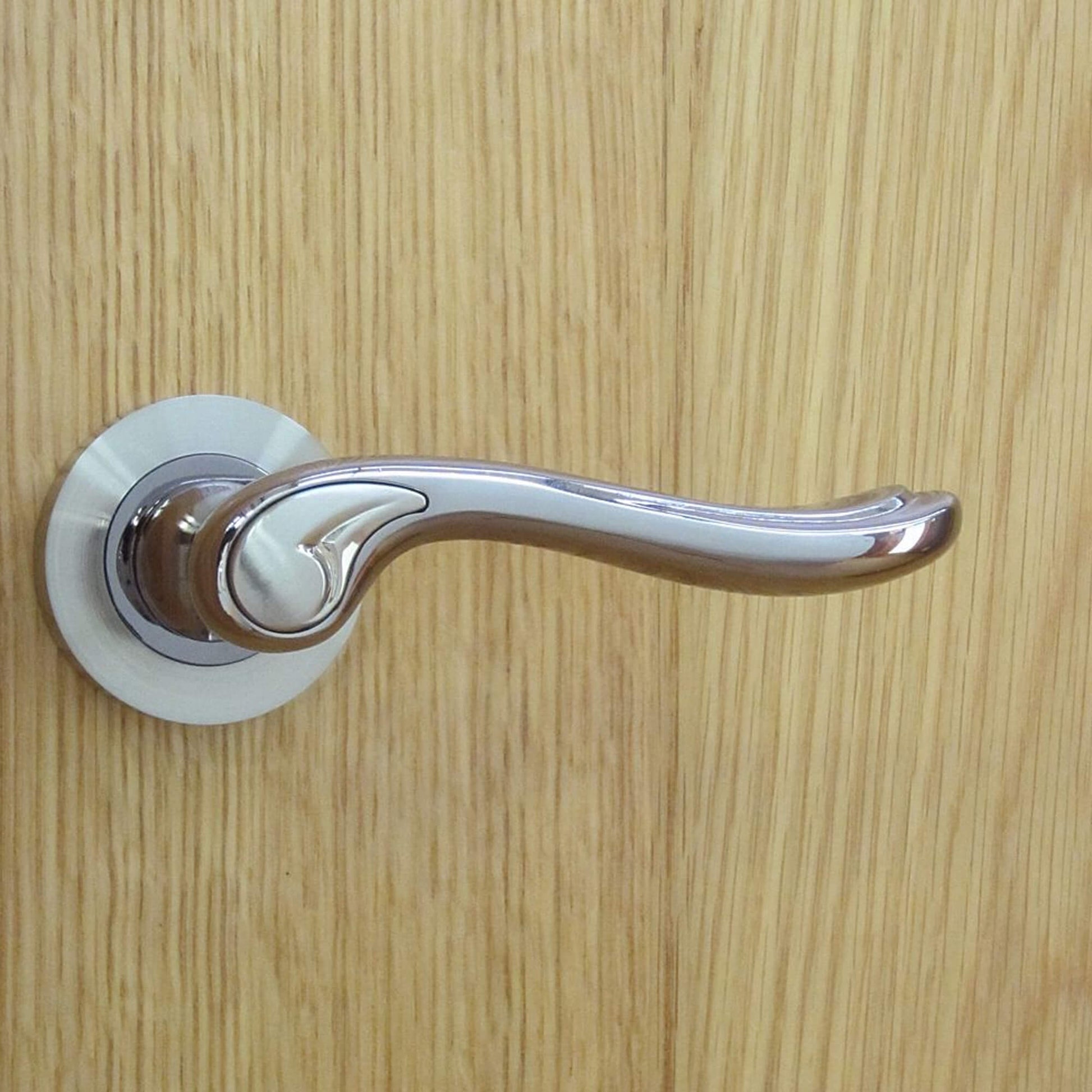 Monet Black Nickel & Nickel Brushed Round Rose Door Handle on a wooden door