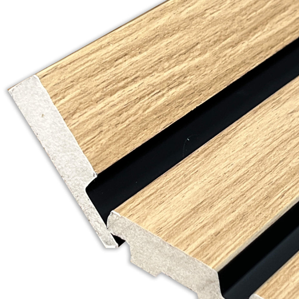 Close-up of a Oak Aqua Slatwall Right Trim being positioned onto a slat wall on a white background