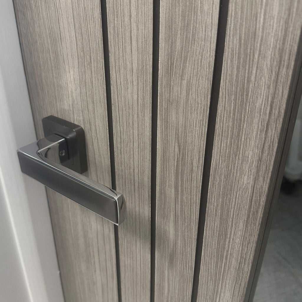 Close-up of a an Ottawa Lava Grey 1 Lite Pre-Glazed 35mm Internal Laminate Door with an Alto door handle and clear 4mm toughened glass inserted.