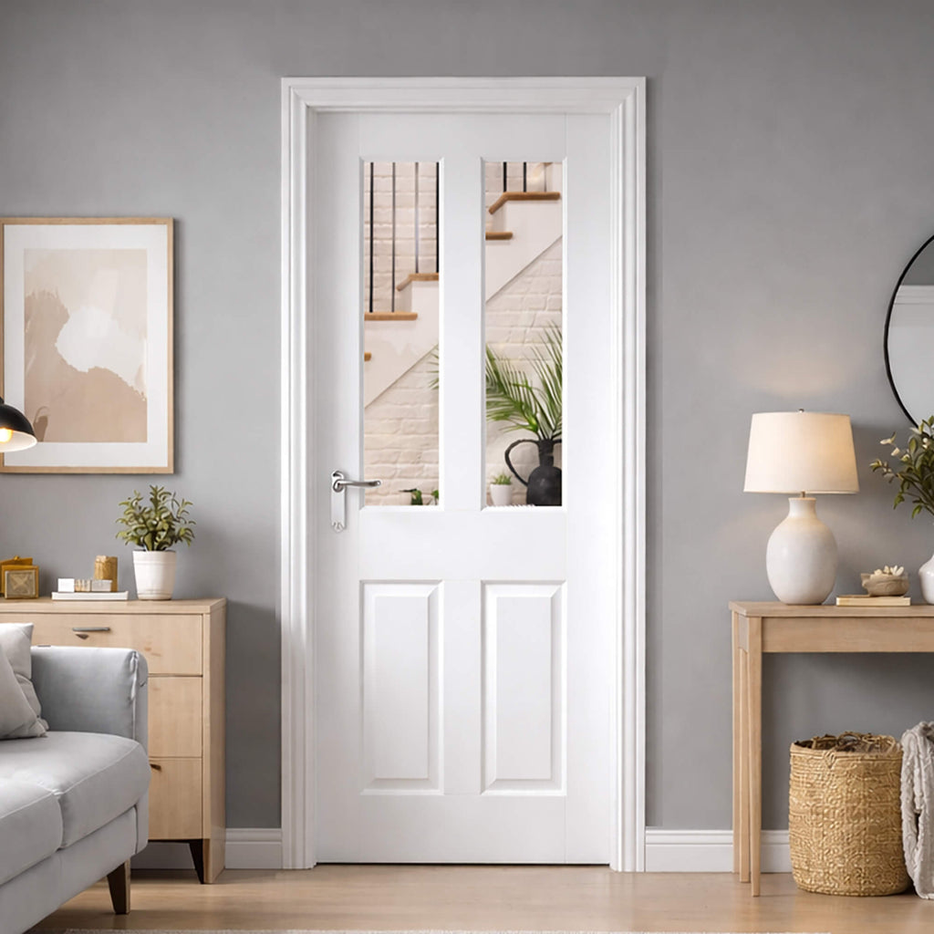 A Oxford White Primed 40mm Pre-Glazed Internal Door in a living room setting with grey walls, wooden furniture, and decorative items, looking out into a hallway.