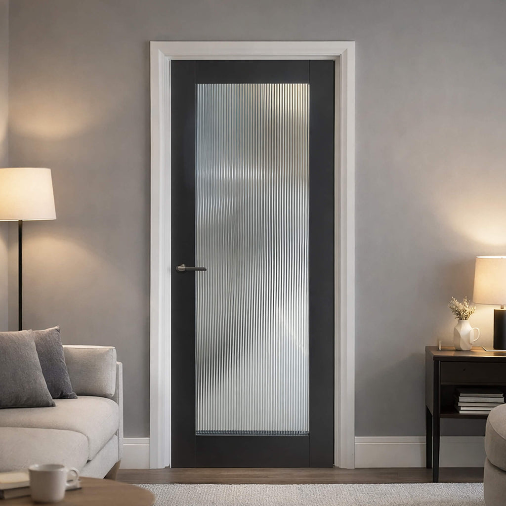 A Reeded Black Primer Plus 1 Lite Pre-Glazed Door in a home interior setting