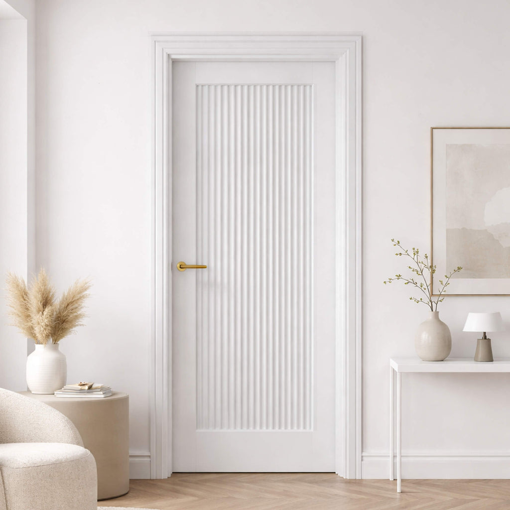 Reeded White Primed 35mm Internal door with gold handle in a minimalistic room with decor elements.