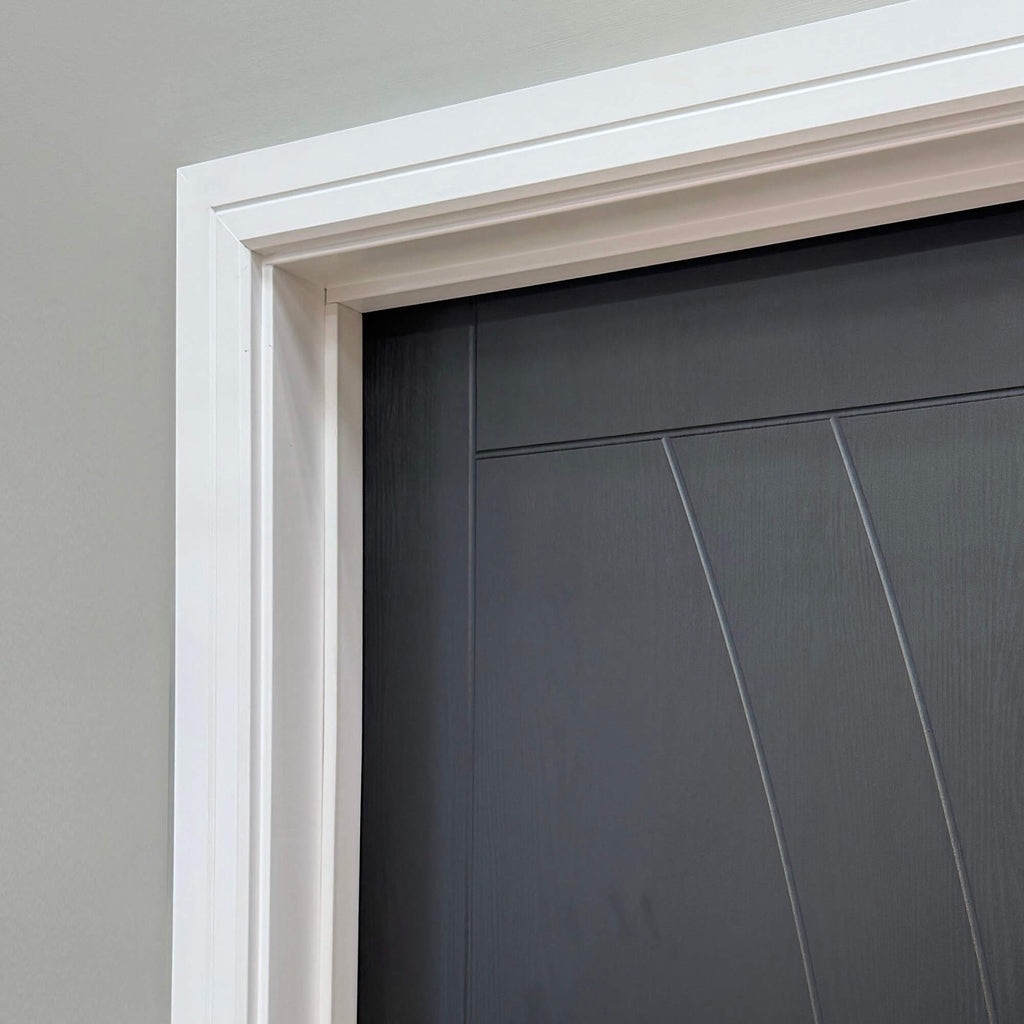 Close-up of a Salerno Black Ash 35mm Laminate Door with white trim against a grey wall.