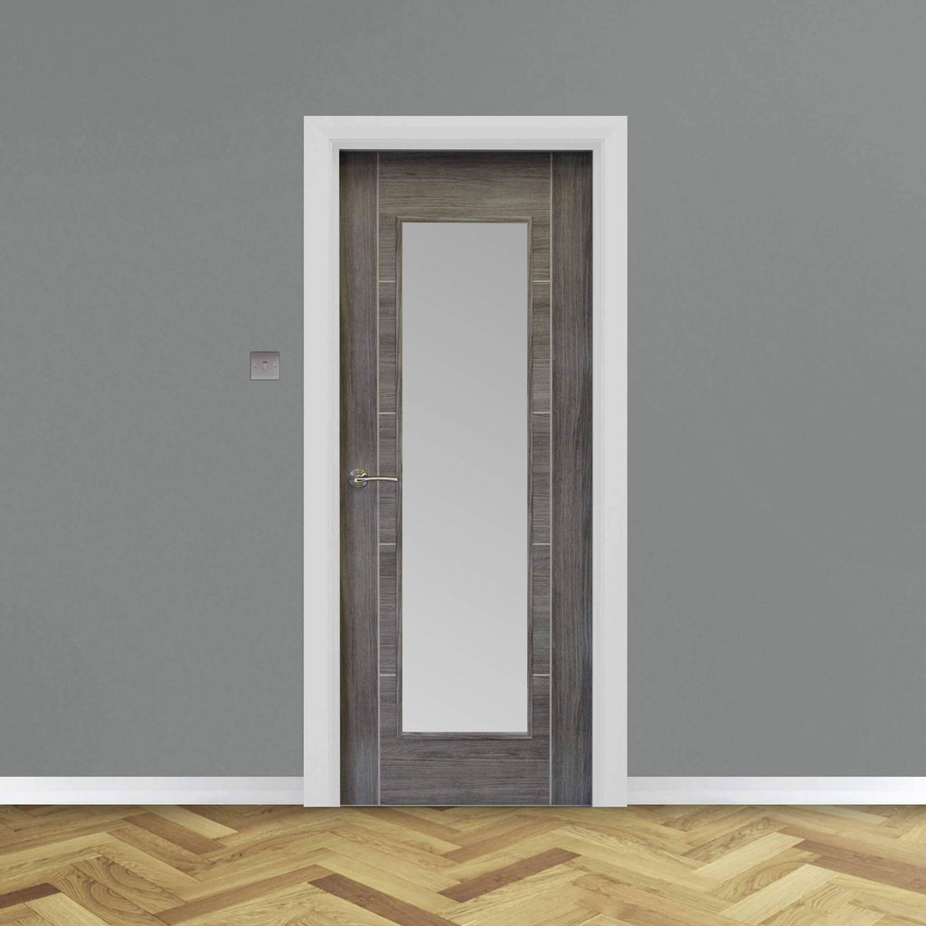 A Tigris Granite Grey 1 Lite Unglazed 40mm Internal Laminate Door, with 4mm sandblasted toughened glass and Storm door handle, in a home interior setting.