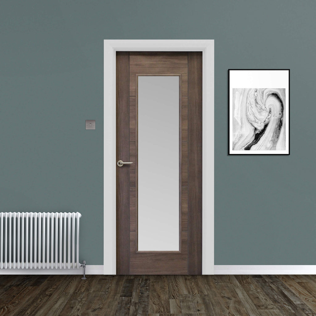 A Tigris Walnut 1 Lite Unglazed Laminate Door, with sandblasted glass inserted, with a Tempest handle in a home interior setting.