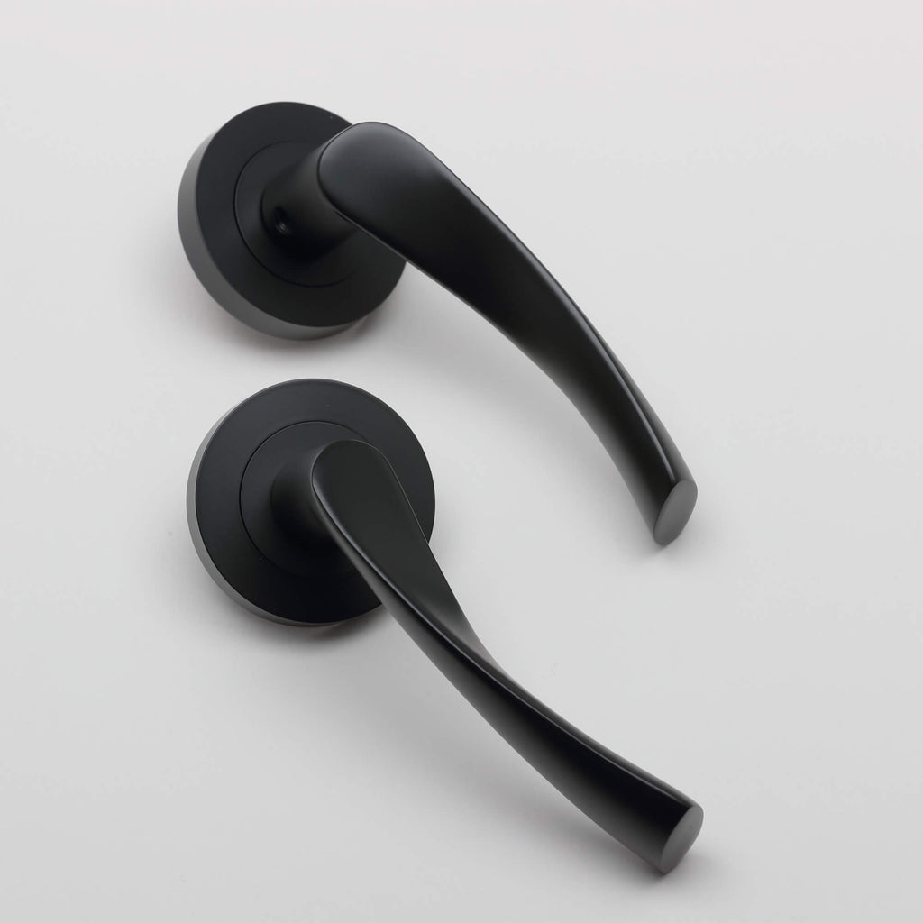 A pair of Trade Range Flat Black door handles on a white background.
