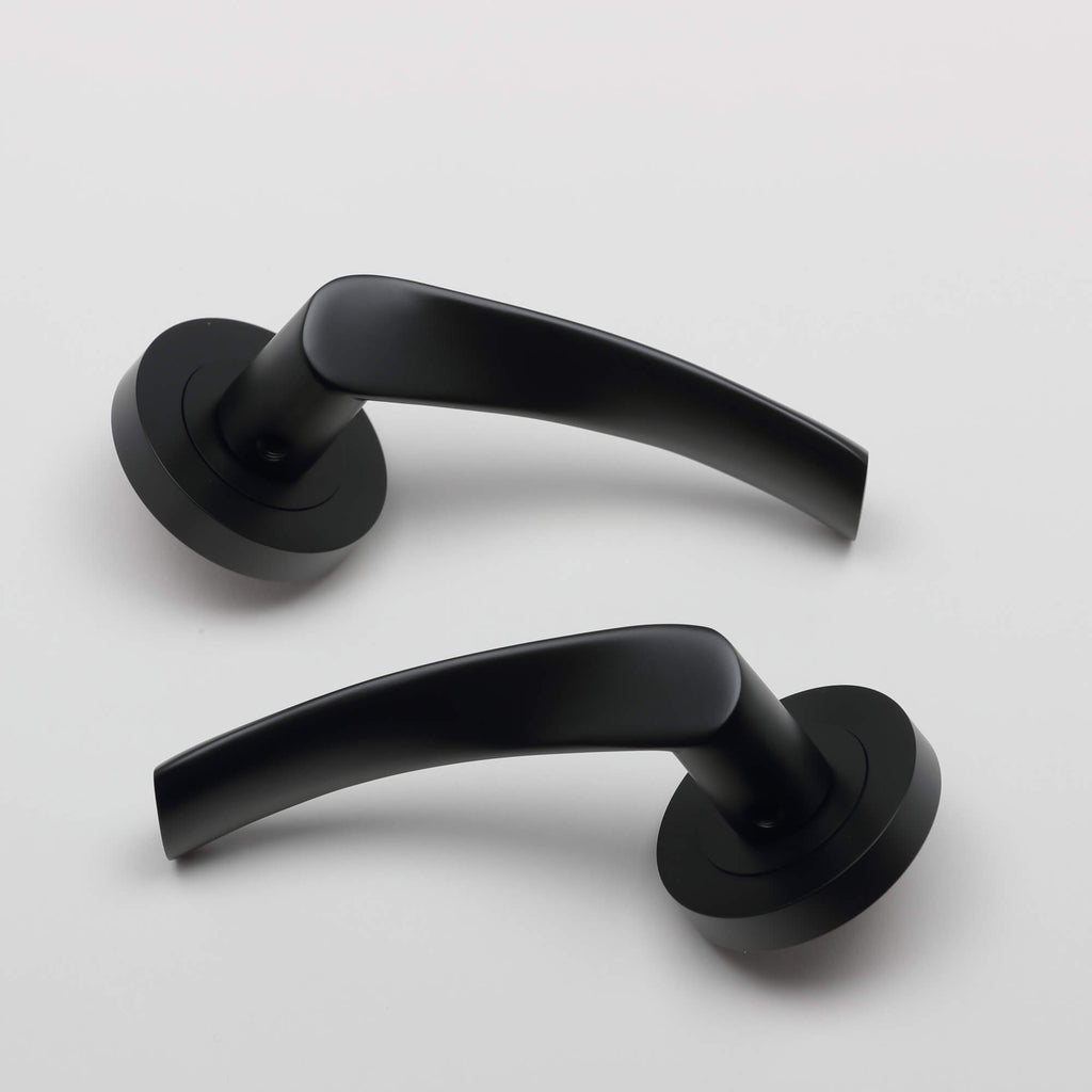 A pair of Trade Range Flat Black door handles on a white background.