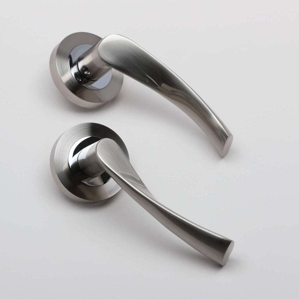 An angled view of a set of Trade Range Nickel Brushed & Polished Chrome door handles on a white background.