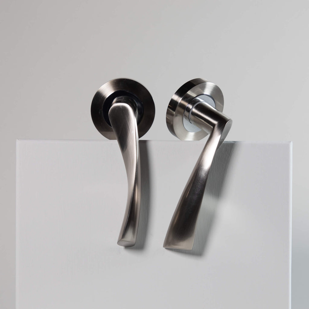 Pair of Trade Range Nickel Brushed & Polished Chrome door handles on a grey background