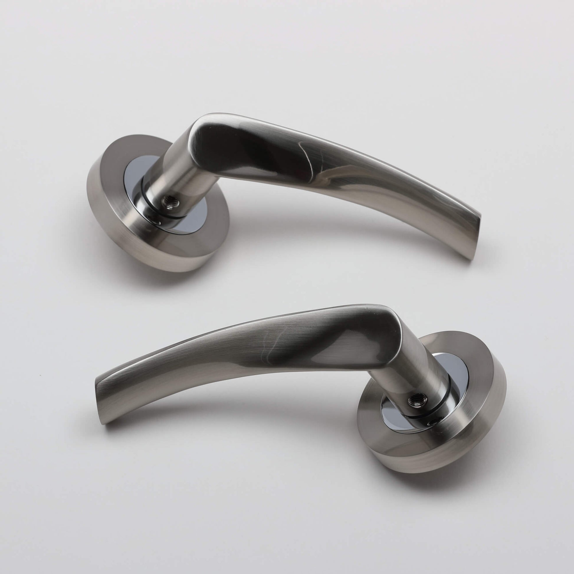 A set of Trade Range Nickel Brushed & Polished Chrome door handles on a white background.