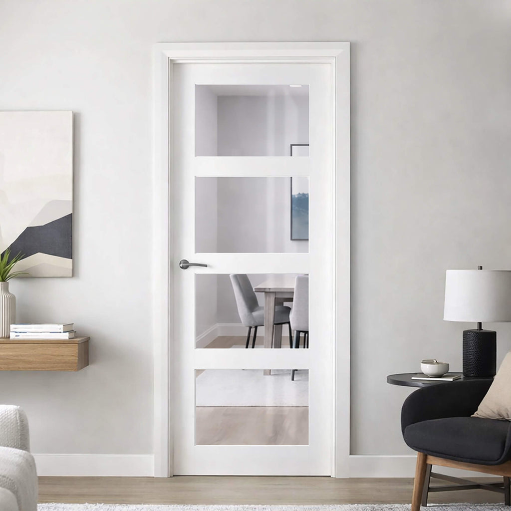 A Trade Spec White Primed Contemporary 4 Lite Pre-Glazed Clear 40mm Internal Door in a living room, looking into a dining room setting.