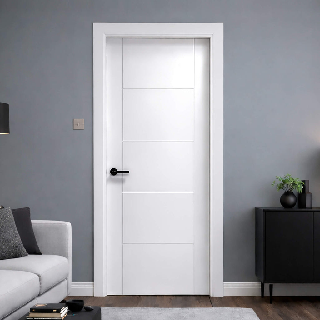 A Vancouver White Primed Paint Grade 35mm Internal Door in a room with grey walls, a black cabinet, and a grey sofa.
