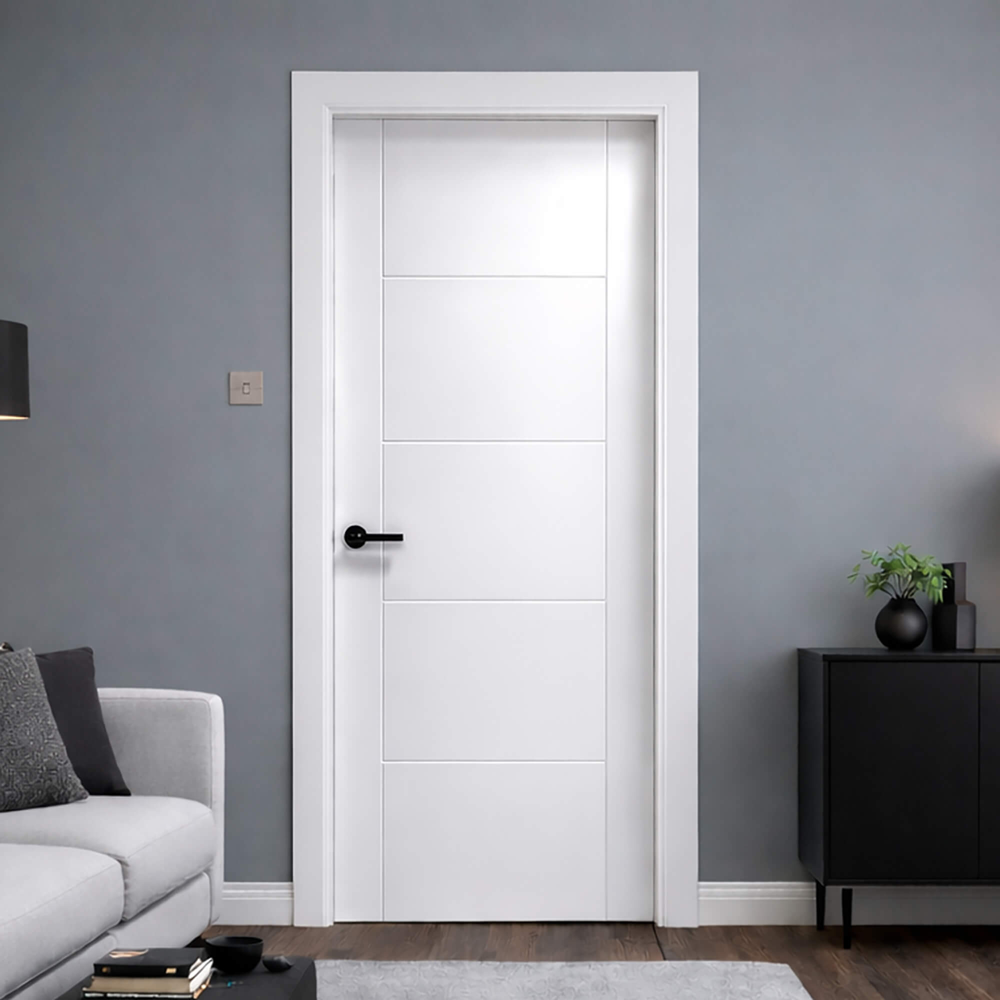A Vancouver White Primed Paint Grade 35mm Internal Door in a room with grey walls, a black cabinet, and a grey sofa.