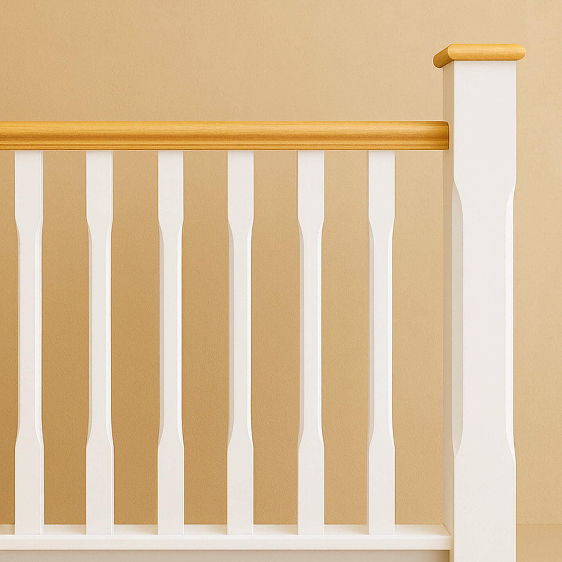 White Primed Chamfered Spindles and Newel Post, with a handrail, against a beige wall.
